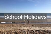 Children playing at the beach in Milford on Sea Hampshire UK