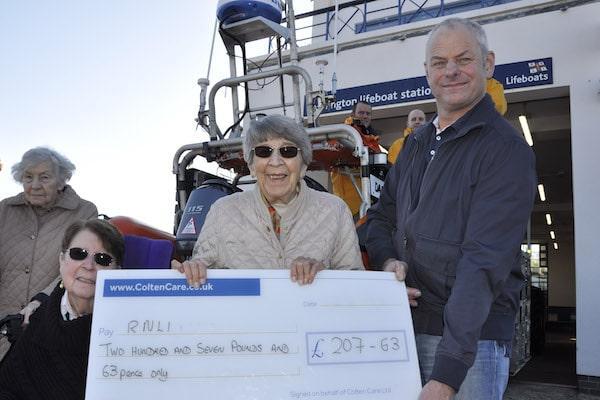 Belmore Lodge care home resident Janette Banks presents the cheque to Nick Hayward, Lifeboat Station Operations Manager at RNLI Lymington